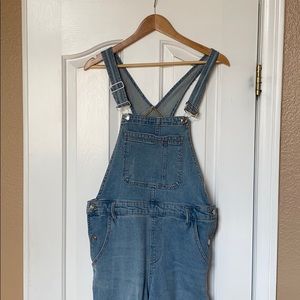 Distressed denim overalls
